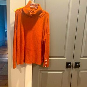 Burt orange turtleneck sweater.